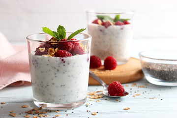 chia pudding with raspberries and granola on a light background. Proper nutrition, super food, healthy breakfast.