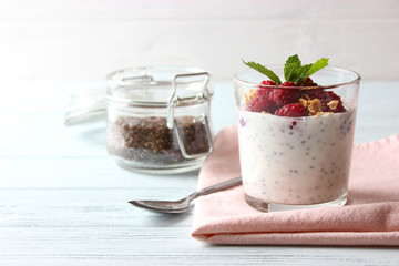chia pudding with raspberries and granola on a light background. Proper nutrition, super food, healthy breakfast.