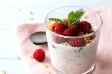 chia pudding with raspberries and granola on a light background. Proper nutrition, super food, healthy breakfast.