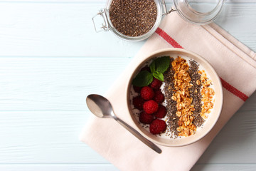 chia pudding in a bowl on the background of a tree view from above. Useful breakfast, useful supplements, super food.
