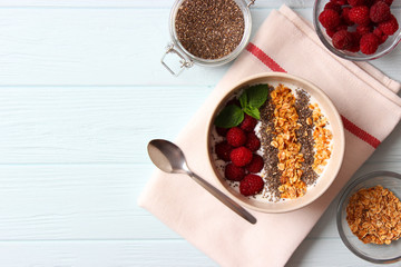 chia pudding in a bowl on the background of a tree view from above. Useful breakfast, useful supplements, super food.