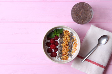 chia pudding in a bowl on the background of a tree view from above. Useful breakfast, useful supplements, super food.