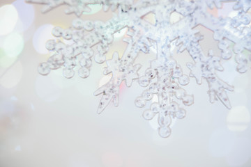 Holidays, winter and celebration concept - Christmas and new year card with snowflake. Blurred background. Unfocused.