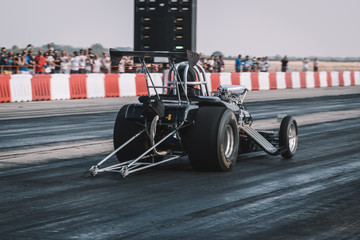 Dragster sets off on the racetrack. Dragster on the speedway. Drag wheel, torque, power, engine...