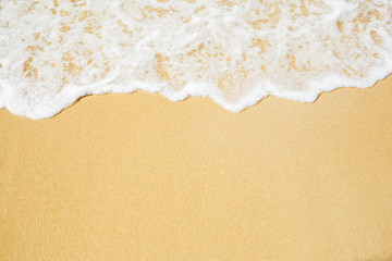 Fototapeta na wymiar Soft wave of sea foam on sandy beach. Background 