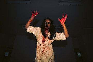 Portrait of asian woman make up ghost face with blood,Horror scene,Scary background,Halloween poster,Thailand people