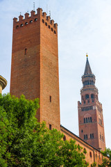 View on the famous Torrazzo bell tower with historic architectures in Cremona, Italy on a sunny day.