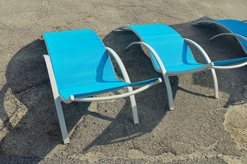 Three empty beach chairs