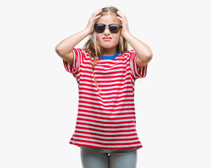 Young beautiful girl wearing sunglasses over isolated background suffering from headache desperate and stressed because pain and migraine. Hands on head.