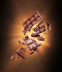 Chocolate bar is torn to pieces in the dark