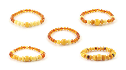 Five different beaded amber bracelet models isolated on white background