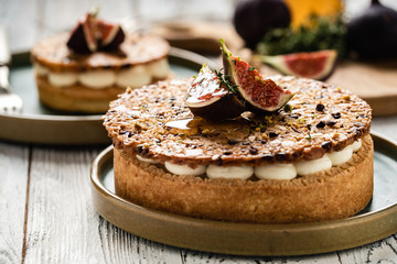 Tarte on sand base with fresh figs, almonds and crispy waffle with almonds and cocoa powder. Fresh Homemade Fruit Tart with berries