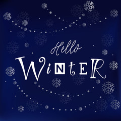 Modern calligraphy lettering of Hello winter in white on dark blue background decorated with silver snowflakes and pearls for decoration, greeting card, poster, banner, sticker, postcard