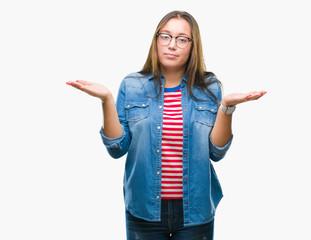 Young beautiful caucasian woman wearing glasses over isolated background clueless and confused...