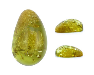 Top view and two side views of one green amber cabochon stone, isolated on white background