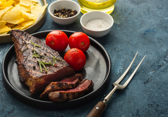 Delicious beef steak with salad, aromatic herbs, chery tomatoes