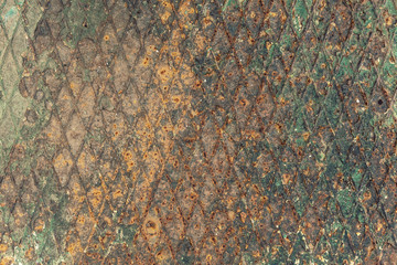 A wall made of iron, with brown rust and green mold. Vintage textured pattern.
