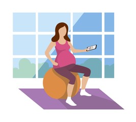 pregnant woman is exercising on a gym ball