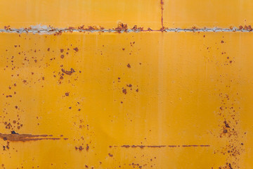 rusted yellow bus board flat background closeup