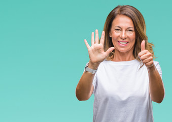 Fototapeta premium Middle age senior hispanic woman over isolated background showing and pointing up with fingers number six while smiling confident and happy.
