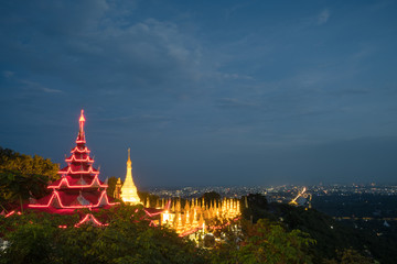 Beautiful golden temple and Pagoda against Blue sky (Twilight time) at top of Mandalay Hill at Mandalay, Myanmar. landmark and popular for tourist attractions