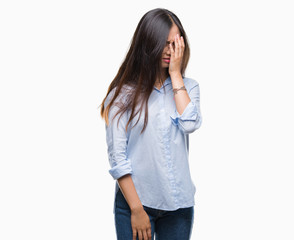 Young asian business woman wearing glasses over isolated background with sad expression covering face with hands while crying. Depression concept.