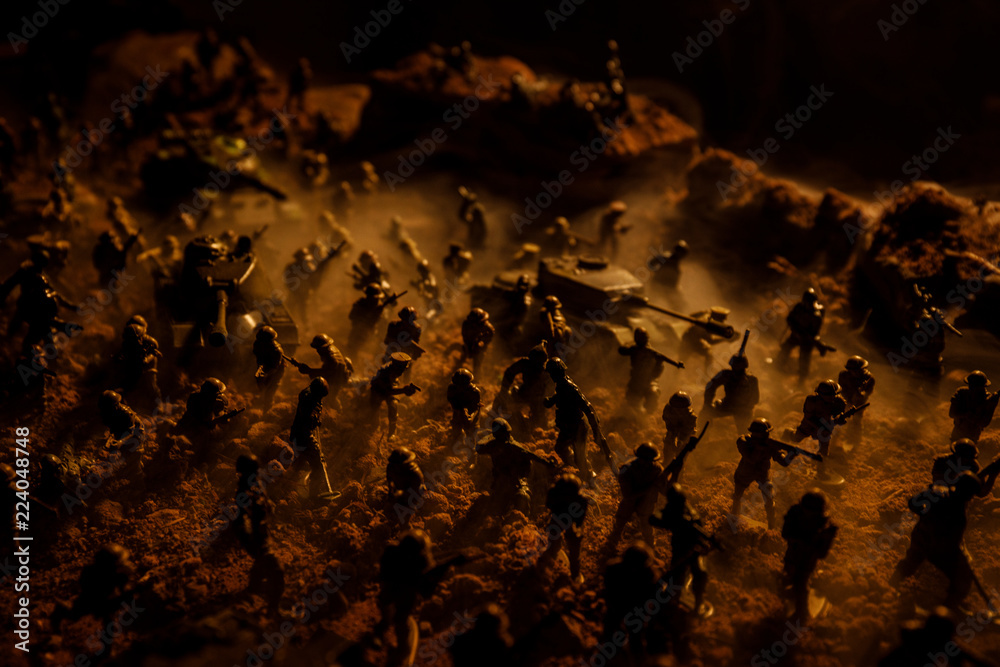 Wall mural War Concept. Military silhouettes fighting scene on war fog sky background, World War Soldiers Silhouettes Below Cloudy Skyline At night. Attack scene. Selective focus Tanks battle. Decoration