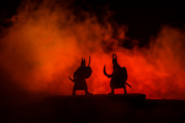 Plakat Silhouette of two samurais in duel. Picture with two samurais and sunset sky