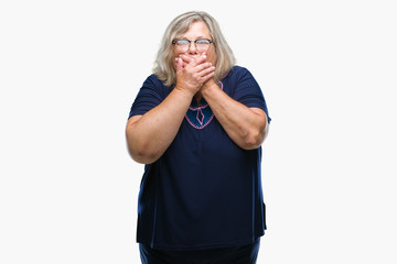 Senior plus size caucasian woman wearing glasses over isolated background shocked covering mouth with hands for mistake. Secret concept.