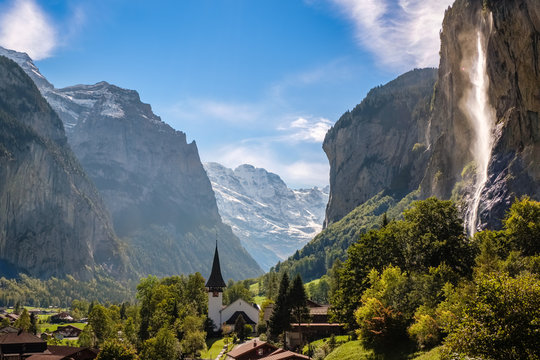 Sun shining on the Staubbach fall (Berner Oberland, Switzerland). Lauterbrunnen lies at the bottom of the Lauterbrunnen valley. It is one of the deepest in the Alpine chain.