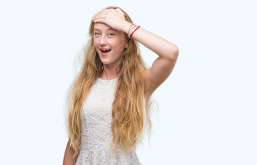 Obraz premium Blonde teenager woman stressed with hand on head, shocked with shame and surprise face, angry and frustrated. Fear and upset for mistake.