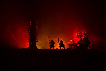 Samurai fighting concept. Silhouette of samurais in duel near tree and old temple. Picture with two...