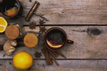 A mulled wine with spices on wooden background