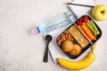 Poster Healthy meal prep containers with cereal bar, fruits, vegetables and snacks. Takeaway food on white background, top view. © vaaseenaa