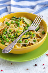 Traditional Farfalle pasta with zucchini and green peas.