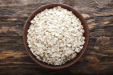 raw oatmeal on a wooden background