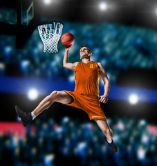 basketball player making slam dunk on basketball arena