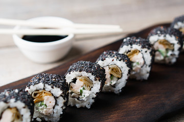 Restaurant menu, Japanese food art. Appetizing sushi rolls served on wooden tray