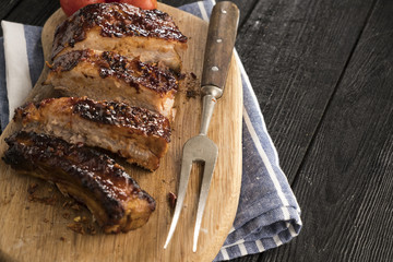 Pork  ribs  with a spicy sauce. on wooden board. Copyspace