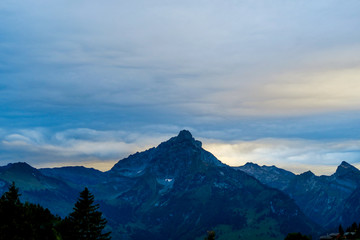 Fototapeta na wymiar Alpine scene in the Swiss mountains: Sunset and storm clouds
