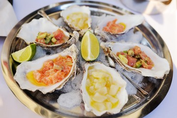 Seafood. Mollusc shellfish. Baked mussels with cheese, cilantro and lemon in oyster shells.