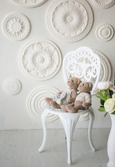 Romantic interior. White chair with toys of bears. Romanticism
