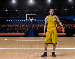 basketball player in yellow uniform standing on basketball court