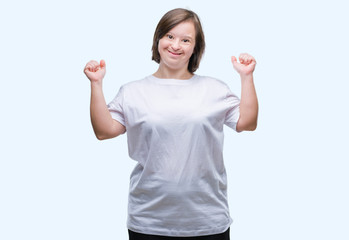 Fototapeta na wymiar Young adult woman with down syndrome over isolated background excited for success with arms raised celebrating victory smiling. Winner concept.