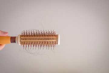 hair fall and lost alopecia woman problem on the comb.