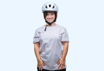 Young adult cyclist woman with down syndrome wearing safety helmet over isolated background with a happy and cool smile on face. Lucky person.