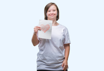 Young adult woman with down syndrome holding red heart card over isolated background with a happy...