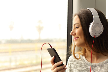 Commuter traveling into a train listening to music