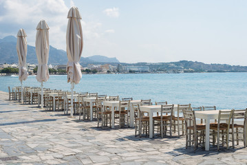 Seafront restaurant chair tables sea ocean view shore island, Greece, Mediterranean