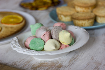 Tea with orange tarts and muffins